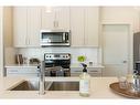 44 Emberside Green, Cochrane, AB  - Indoor Photo Showing Kitchen With Double Sink With Upgraded Kitchen 