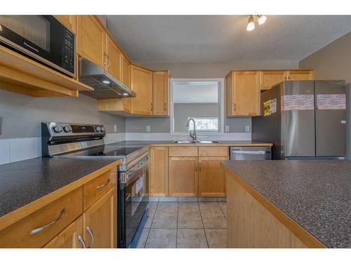 115 Hidden Creek Cove Nw, Calgary, AB - Indoor Photo Showing Kitchen With Double Sink