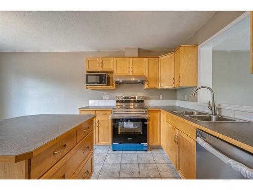 115 Hidden Creek Cove Nw, Calgary, AB - Indoor Photo Showing Kitchen With Double Sink