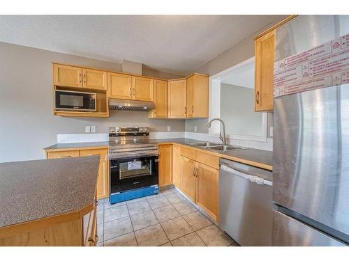 115 Hidden Creek Cove Nw, Calgary, AB - Indoor Photo Showing Kitchen With Stainless Steel Kitchen With Double Sink