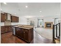 102 Cranarch Common Se, Calgary, AB  - Indoor Photo Showing Kitchen With Fireplace 