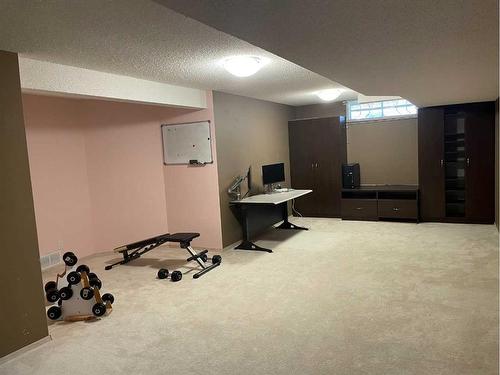 65 Shawnee Crescent Sw, Calgary, AB - Indoor Photo Showing Gym Room