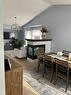 65 Shawnee Crescent Sw, Calgary, AB  - Indoor Photo Showing Dining Room With Fireplace 