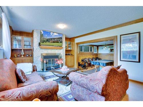 42 Lake Ere Estates, Chestermere, AB - Indoor Photo Showing Living Room With Fireplace