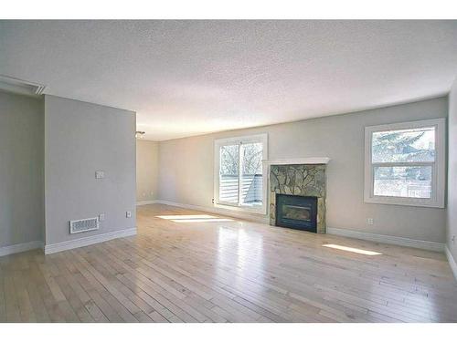 279-86 Glamis Green Sw, Calgary, AB - Indoor Photo Showing Living Room With Fireplace