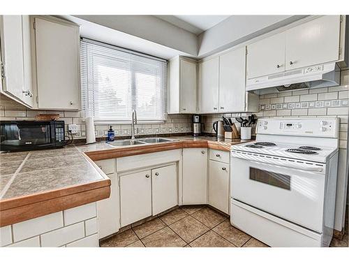 25 Rossmount Road Sw, Calgary, AB - Indoor Photo Showing Kitchen With Double Sink