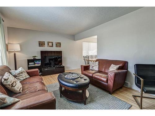 25 Rossmount Road Sw, Calgary, AB - Indoor Photo Showing Living Room With Fireplace