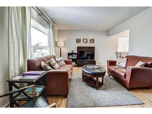 25 Rossmount Road Sw, Calgary, AB - Indoor Photo Showing Living Room With Fireplace