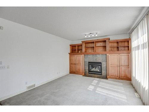 133 Evergreen Plaza Sw, Calgary, AB - Indoor Photo Showing Living Room With Fireplace