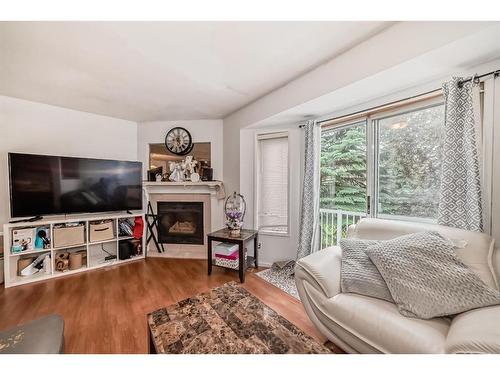 252 Shawinigan Drive Sw, Calgary, AB - Indoor Photo Showing Living Room With Fireplace