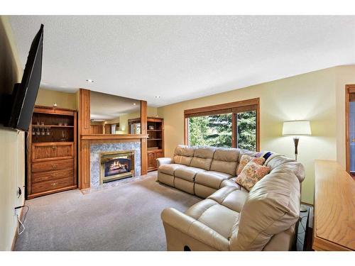 75 Schubert Hill Nw, Calgary, AB - Indoor Photo Showing Living Room With Fireplace