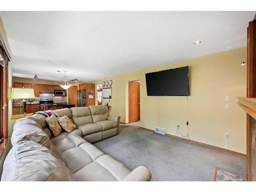 75 Schubert Hill Nw, Calgary, AB - Indoor Photo Showing Living Room With Fireplace