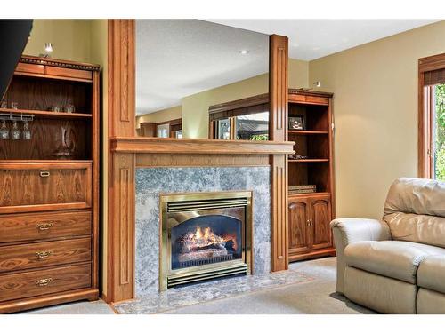 75 Schubert Hill Nw, Calgary, AB - Indoor Photo Showing Living Room With Fireplace