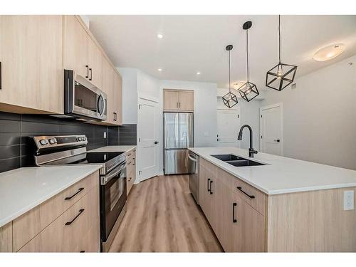 2405-55 Lucas Way, Calgary, AB - Indoor Photo Showing Kitchen With Stainless Steel Kitchen With Double Sink With Upgraded Kitchen