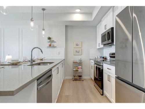 104-245 Edith Place Nw, Calgary, AB - Indoor Photo Showing Kitchen With Upgraded Kitchen