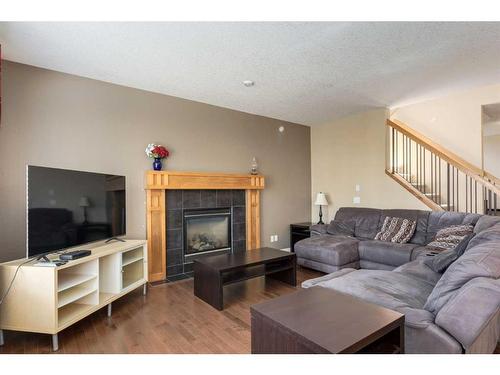 40 Copperstone Gate Se, Calgary, AB - Indoor Photo Showing Living Room With Fireplace