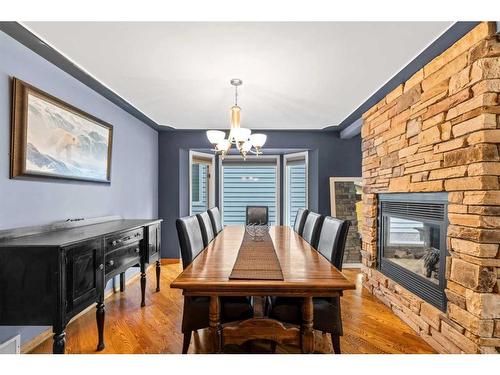 33 Sunhaven Close Se, Calgary, AB - Indoor Photo Showing Dining Room With Fireplace