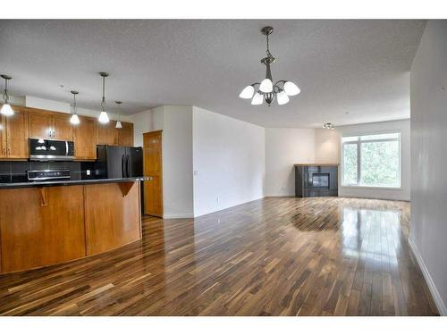 1308-24 Hemlock Crescent Sw, Calgary, AB - Indoor Photo Showing Kitchen With Fireplace