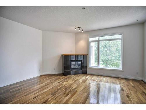 1308-24 Hemlock Crescent Sw, Calgary, AB - Indoor Photo Showing Living Room With Fireplace