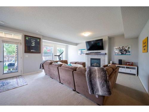 66 Auburn Sound Close Se, Calgary, AB - Indoor Photo Showing Living Room With Fireplace