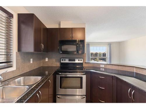 2401-60 Panatella Street Nw, Calgary, AB - Indoor Photo Showing Kitchen With Double Sink