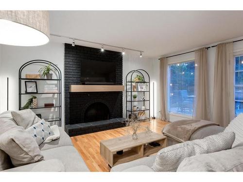 73 Stratford Place Sw, Calgary, AB - Indoor Photo Showing Living Room With Fireplace