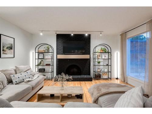 73 Stratford Place Sw, Calgary, AB - Indoor Photo Showing Living Room With Fireplace