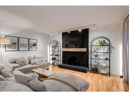 73 Stratford Place Sw, Calgary, AB - Indoor Photo Showing Living Room With Fireplace