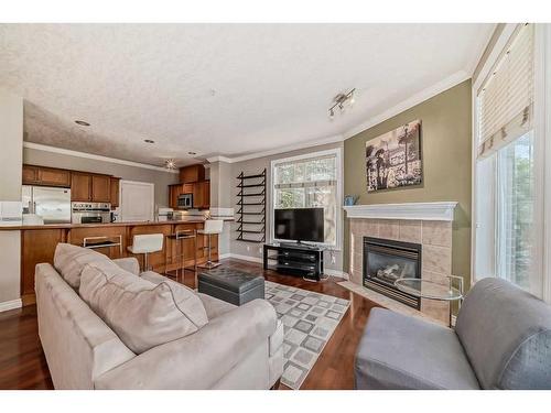 214-59 22 Avenue Sw, Calgary, AB - Indoor Photo Showing Living Room With Fireplace