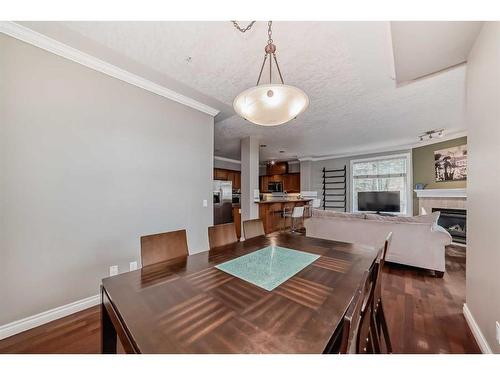 214-59 22 Avenue Sw, Calgary, AB - Indoor Photo Showing Dining Room With Fireplace