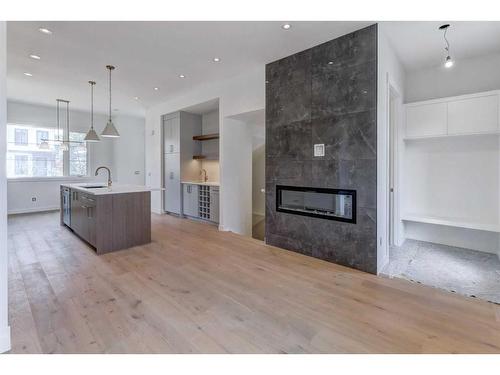 912 32 Street Nw, Calgary, AB - Indoor Photo Showing Living Room With Fireplace