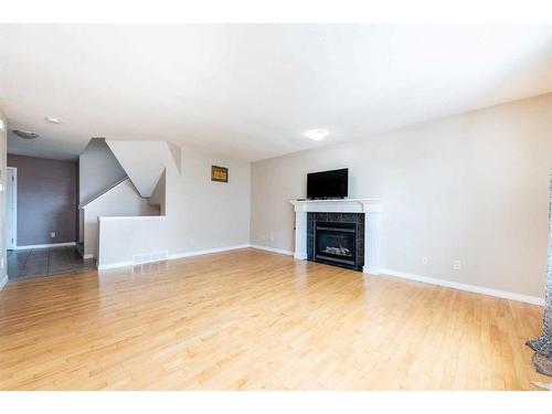 7 Saddlecrest Terrace Ne, Calgary, AB - Indoor Photo Showing Living Room With Fireplace