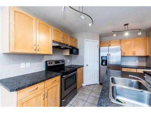 7 Saddlecrest Terrace Ne, Calgary, AB - Indoor Photo Showing Kitchen With Stainless Steel Kitchen With Double Sink