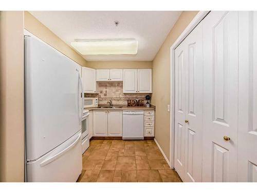 3324-3000 Millrise Point Sw, Calgary, AB - Indoor Photo Showing Kitchen With Double Sink