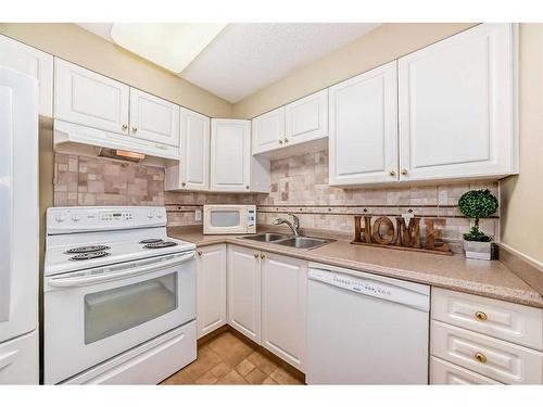 3324-3000 Millrise Point Sw, Calgary, AB - Indoor Photo Showing Kitchen With Double Sink