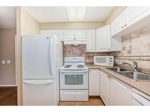 3324-3000 Millrise Point Sw, Calgary, AB - Indoor Photo Showing Kitchen With Double Sink