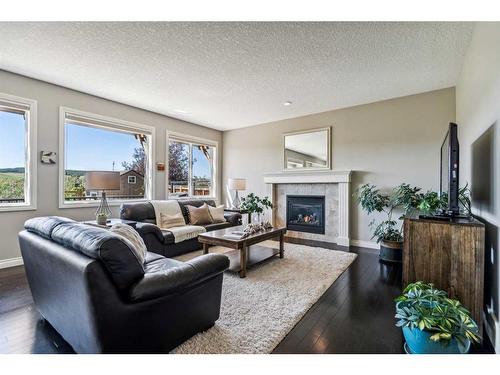 63 Jumping Pound Terrace, Cochrane, AB - Indoor Photo Showing Living Room With Fireplace