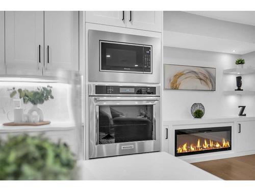 1028 Lake Ontario Drive Se, Calgary, AB - Indoor Photo Showing Kitchen With Fireplace