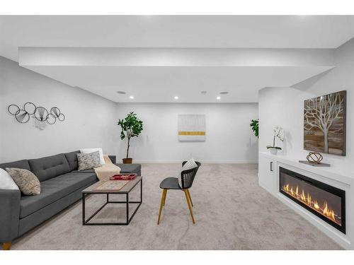 1028 Lake Ontario Drive Se, Calgary, AB - Indoor Photo Showing Living Room With Fireplace