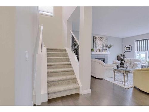 116 Sunset Manor, Cochrane, AB - Indoor Photo Showing Other Room With Fireplace