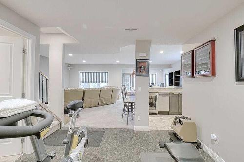 116 Sunset Manor, Cochrane, AB - Indoor Photo Showing Gym Room