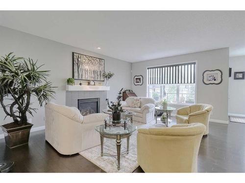 116 Sunset Manor, Cochrane, AB - Indoor Photo Showing Living Room With Fireplace