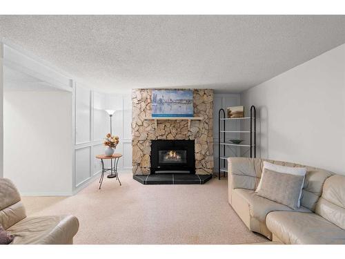 5852 Dalmead Crescent Nw, Calgary, AB - Indoor Photo Showing Living Room With Fireplace