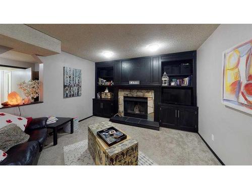 121 Sunbank Way Se, Calgary, AB - Indoor Photo Showing Living Room With Fireplace