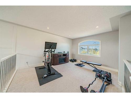 168 Kinniburgh Boulevard, Chestermere, AB - Indoor Photo Showing Gym Room