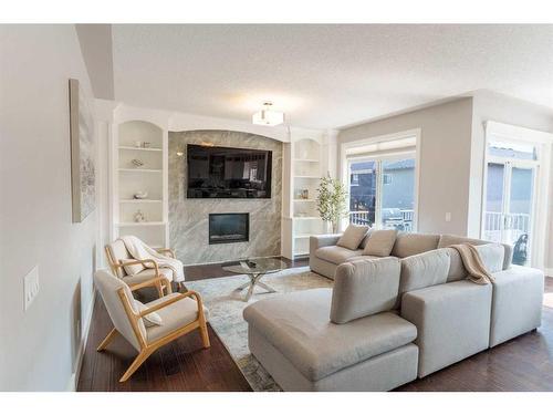 168 Kinniburgh Boulevard, Chestermere, AB - Indoor Photo Showing Living Room With Fireplace