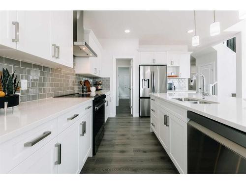 35 Saddlebred Place, Cochrane, AB - Indoor Photo Showing Kitchen With Double Sink With Upgraded Kitchen