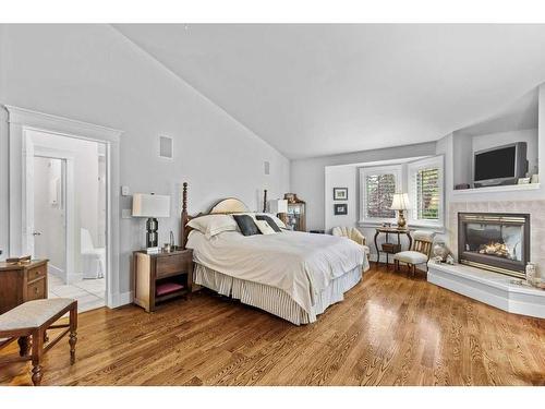 149 Carey, Canmore, AB - Indoor Photo Showing Bedroom With Fireplace