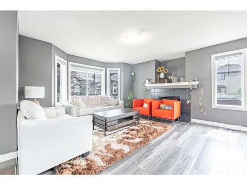 335 Saddlebrook Circle Ne, Calgary, AB - Indoor Photo Showing Living Room With Fireplace