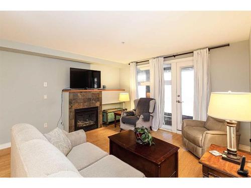 208-725 4 Street Ne, Calgary, AB - Indoor Photo Showing Living Room With Fireplace